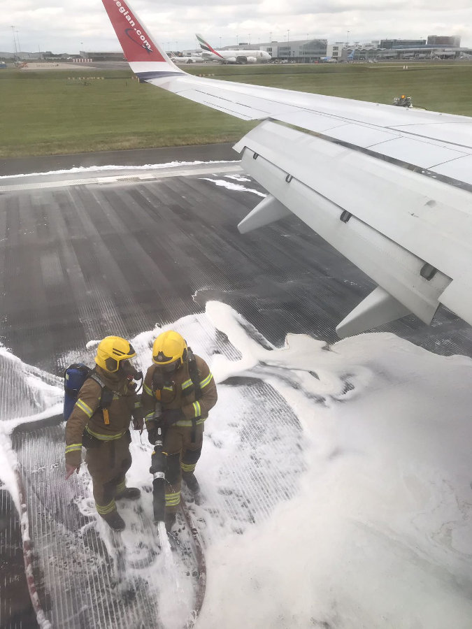 Inside passenger view of the D86241 Norwegian Air airplane while Birmingham Airport firefighters use anti-fire foam. Photo by: Via News.