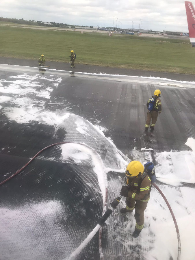 Inside passenger view of the D86241 Norwegian Air airplane while anti-fire foam is sprayed. Photo by: Via News.