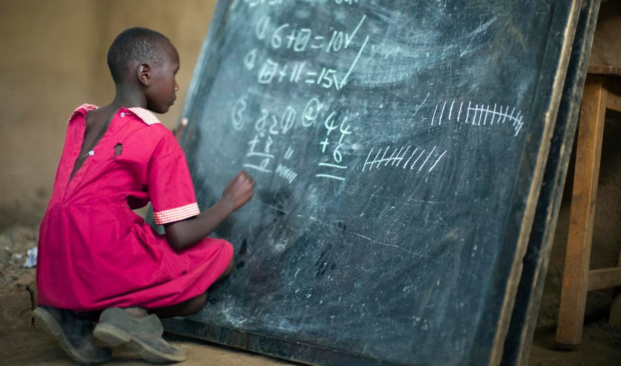 Masai girl at school doing maths (Kenya). Photo by: Christopher Michel