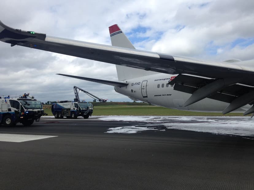 Birmingham Airport fire trucks sprayed the plane to prevent fire. Photo by: Via News.