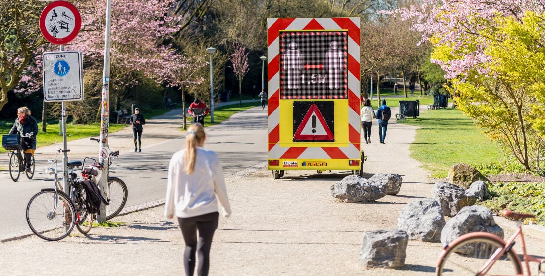 Public park with social distancing warning. Photo by: Thomas Richardson.