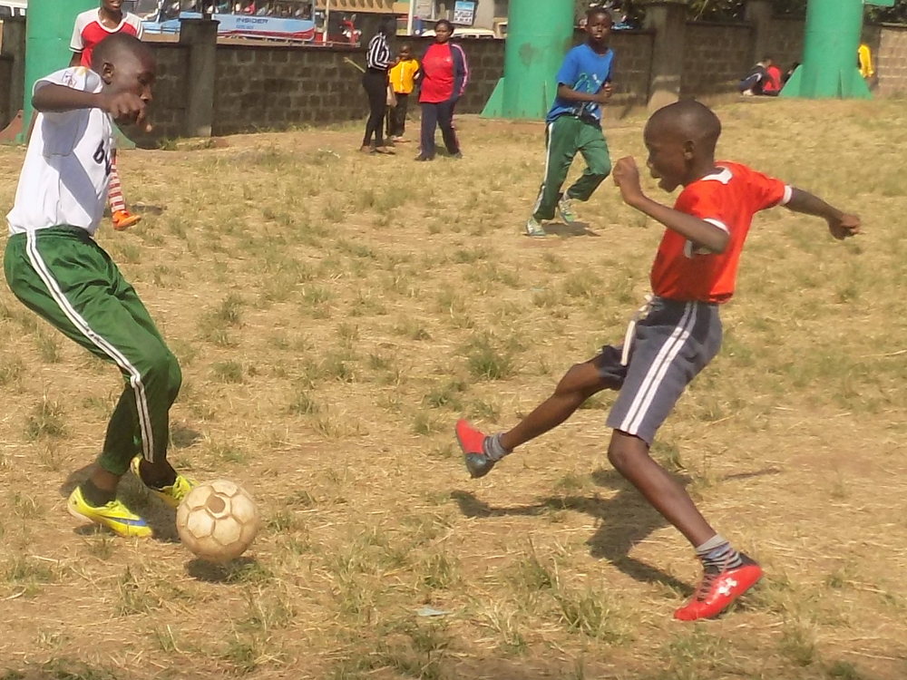 John Nyanganyi (left) attempts to dribble past Cosmas Asunga during Sports Day at Moi Avenue Primary School on Wednesday. Photo by: Ronnie Evans.