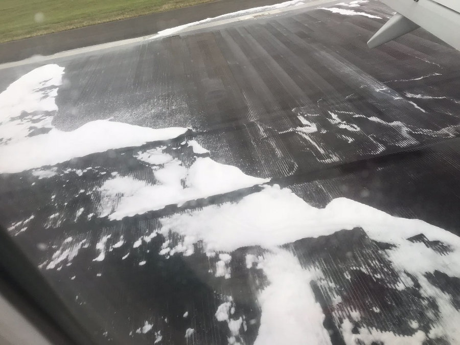 Inside passenger view of the D86241 Norwegian Air airplane while anti-fire foam is sprayed. Photo by: Via News.
