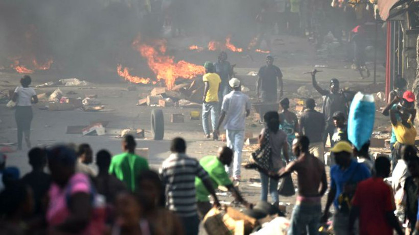 Haiti unrest: Protesters pillaged stores, torched cars.