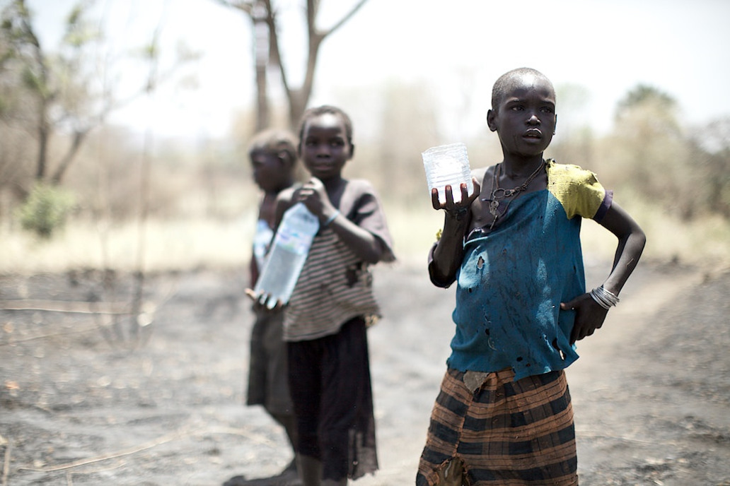 South Sudan girls collected water from a recently opened borehole. Water that, if contaminated, may pose a serious health threat. Photo by: Arsenie Coseac.