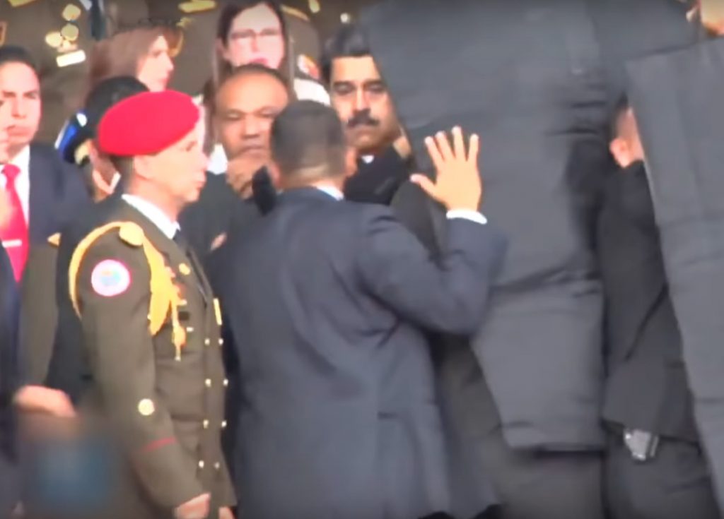 President Maduro being secured by government staff moments after the first drone exploded.