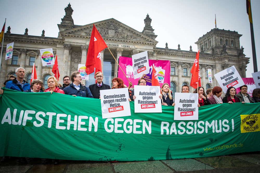 Protest against the AfD in the Bundestag. The sign reads "Stand up against racism". Photo by: Martin Heinlein.