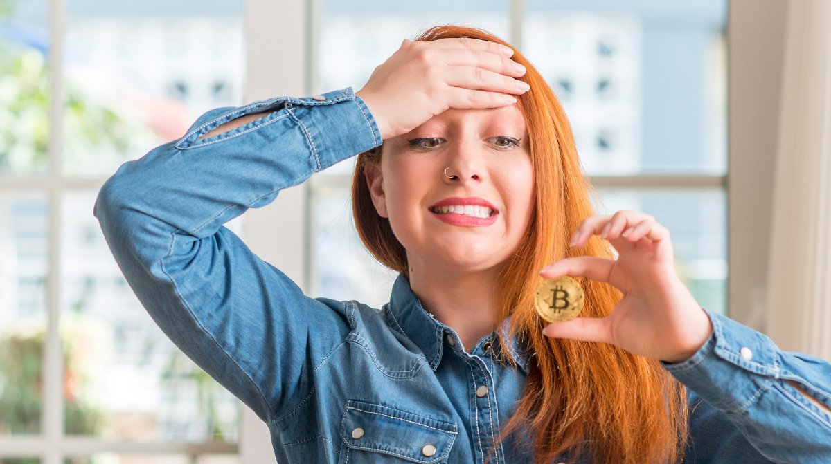 Woman holding bitcoin cryptocurrency coin.